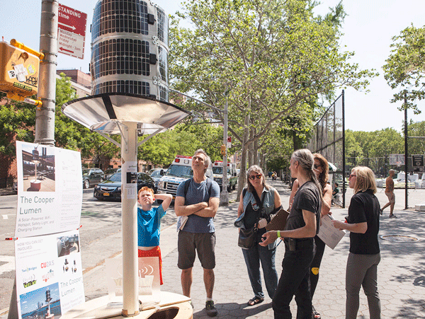 Paul Garrin, third from right, explaining the Cooper Lumen to people in S.D.R. Park during Ideas City.