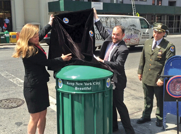 Sanitation Commissioner Kathryn Garcia, left, and Councilmember Corey Johnson unveiled a new “big belly”-style trash can at W. 14th St. and Eighth Ave.