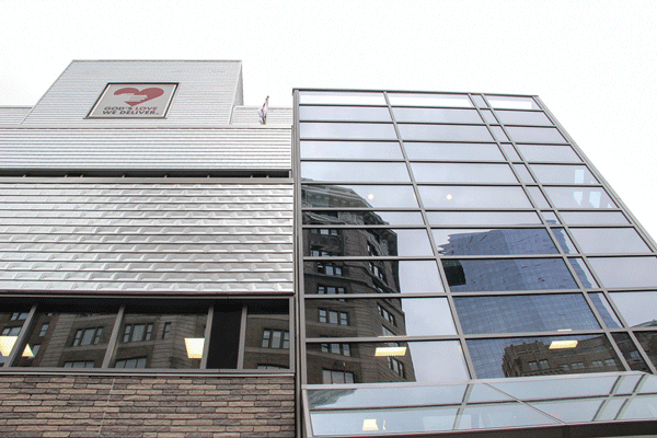 The facade of the new, enlarged God’s Love building features a mix of materials, in contrast to the much more humble two-story brick building it replaced.