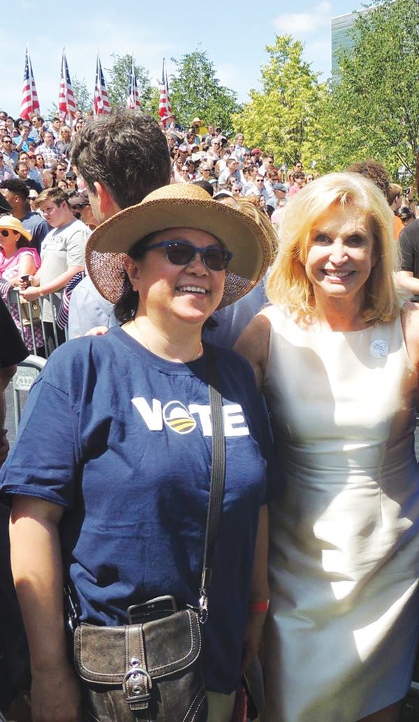 Councilmember Rosie Mendez, left, and Congressmember Carolyn Maloney were relishing the moment at Hillary Clinton’s campaign kickoff speech on Roosevelt Island Saturday morning. The island is in Maloney’s district.  Photo by Marilyn Abalos