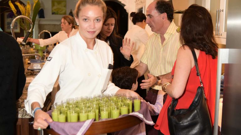 Chef Jackie McKay serves refreshments during a book party on Saturday, June 6, 2015, for Wednesday Martin's 