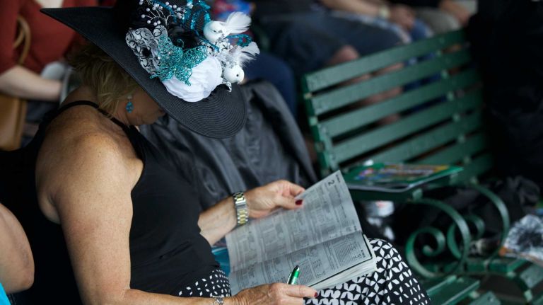 Eileen Ryan of Rancho Cucamonga, CA, checks the racing forum before the 147th running of the Belmont Stakes at Belmont Park Race Track in Elmont, June 6, 2015