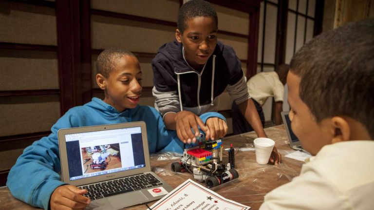 How NYC is helping train its youngest minds in STEM 2 Taikuan Perkins and Adonis Lemos, 6th grade students from Renaissance Leadership School explain how their 'Health Helper Robot Prototype' works to another participant as part of the New York Public Library's