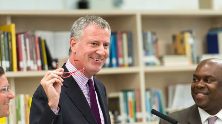 Mayor Bill de Blasio announced that the City of New York will partner with Warby Parker to provide a free pair of eye glasses to over 20,000 city school students. Mayor de Blasio and Richard Buery, deputy mayor for Strategic Policy Initiatives, show a pair of sample eyeglasses at a news conference on Wednesday, June 24, 2015, at the Vito Marcantonio P.S. 50 School.