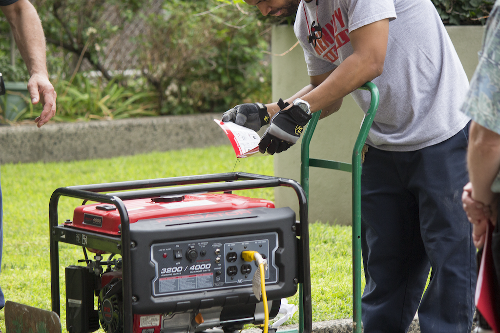 The residents simulated hooking up a portable generator to provide power in a blackout.