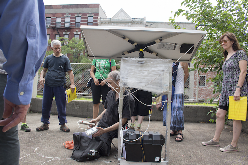 Paul Garrin simulated setting up a solar-powered station for WiFi and phone charging.