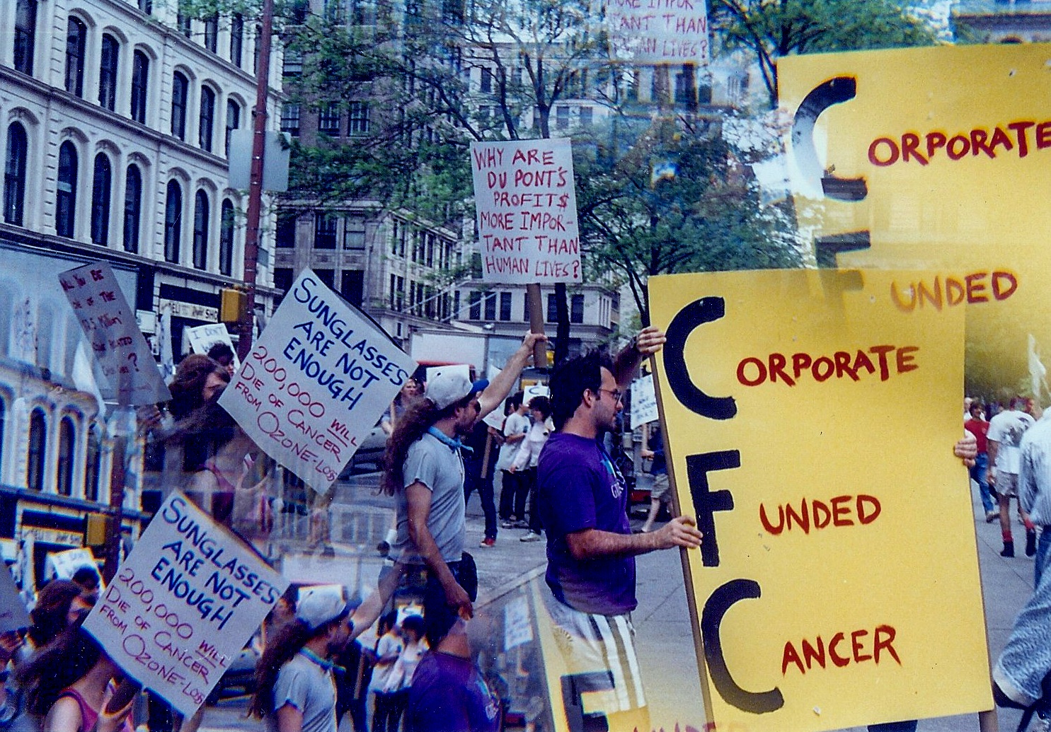 A collage-style photo from a past Time's Up protest in Lower Manhattan against ozone depletion.