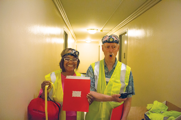 Residents wearing headlamps prepped to help during the simulated power outage.   PHOTO BY CODY BROOKS