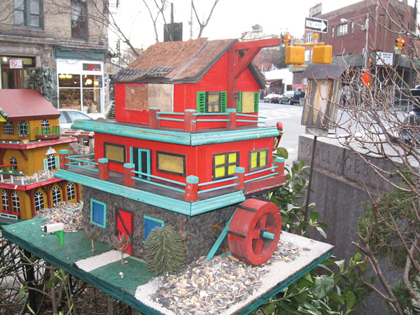 In addition to the World War II monument, McCarthy Square is also known for its elaborate bird feeders, including this mill.   File photo by Lincoln Anderson