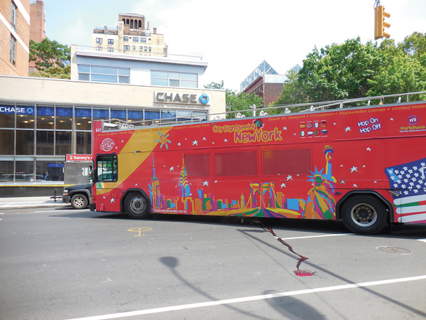 A stream of blood was left on Sixth Ave. after the bus struck a crossing pedestrian.   Photos by Sharon Woolums