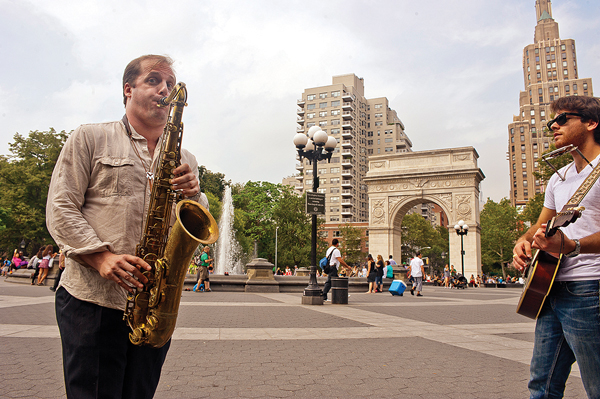 David Sobel, on sax, jammed with folk singer Andre Romiel, on guitar and harmonica, in Washington Square Park on July 4.   Photos by Susan Farley