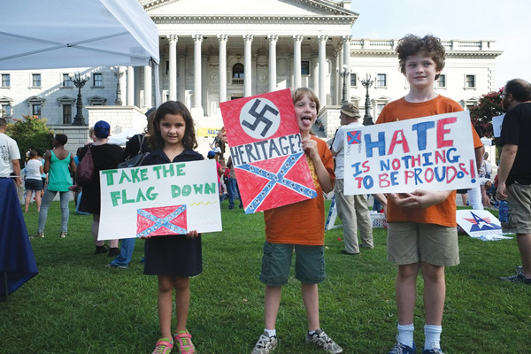Demonstrators sang and held protest signs at the July 4 “Take Down the Flag” rally at the South Carolina capitol.