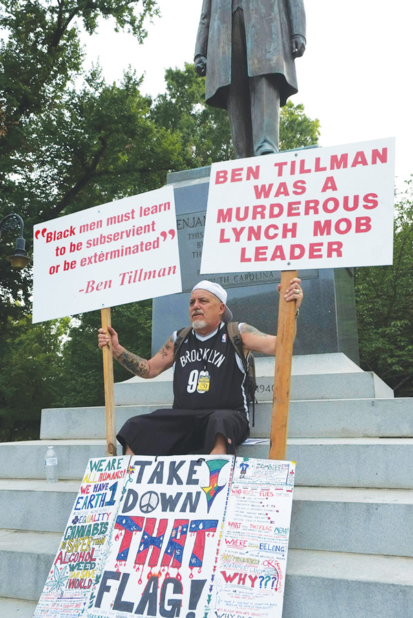 Activist John Penley in front of a statue to rabid racist Governor Benjamin Tillman.