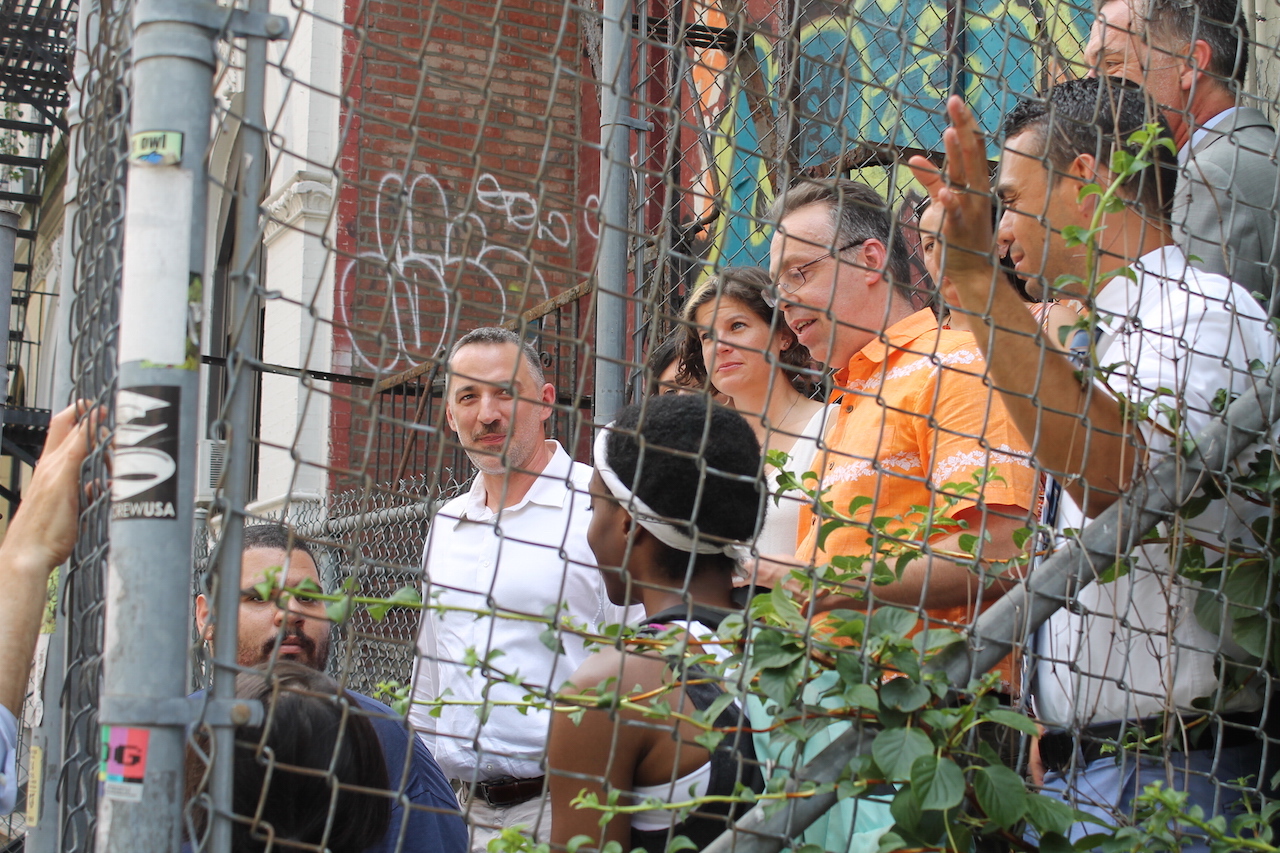 As Steve Herrick, in orange shirt, of the Cooper Square Committee spoke about the project, Carl Siciliano of the Ali Forney Center, looking toward camera, and homeless gay youth and advocates listened. Photos by Lincoln Anderson