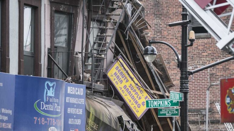 A four-story building at 1438 Fulton St. in the Bed-Stuy section of Brooklyn, collapsed just before 2:30 p.m. on Tuesday, July 14, 2014. The FDNY says at least three passers-by were treated for non-life-threatening injuries after being hit by fallen debris.