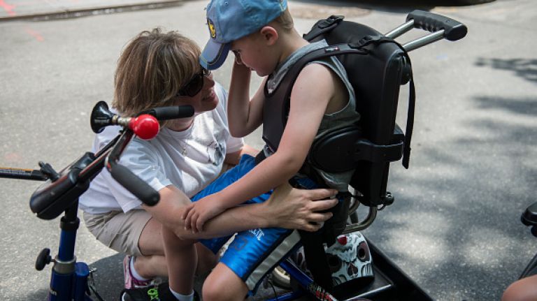Scenes from the first annual Disability Pride parade in NYC 28 A mother comforts her son during the first annual Disability Pride Parade on July 12, 2015 in New York City. The parade calls attention to the rights of people with disabilities and coincides with the 25th anniversary of the Americans with Disabilities Act.