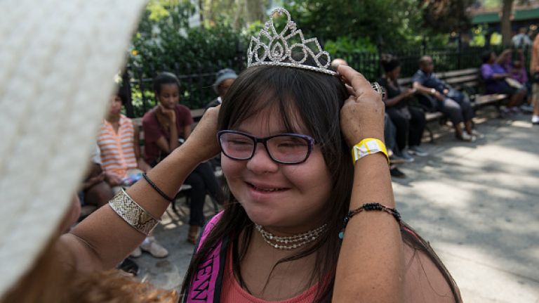Scenes from the first annual Disability Pride parade in NYC 32 Roxanne Fernandez, a 14-year-old with down syndrome, gets help from her Mother putting on her tiara during the first annual Disability Pride Parade on July 12, 2015 in New York City. The parade calls attention to the rights of people with disabilities and coincides with the 25th anniversary of the Americans with Disabilities Act.