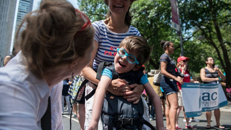Scenes from the first annual Disability Pride parade in NYC 35 Andrea Ryder holds her son, Max during the first annual Disability Pride Parade on July 12, 2015 in New York City. The parade calls attention to the rights of people with disabilities and coincides with the 25th anniversary of the Americans with Disabilities Act.