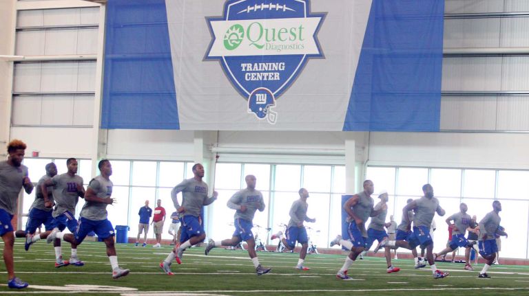 Members of the New York Giants run during team conditioning drills at the Quest Diagnostics Training Center in East Rutherford, N.J., on Thursday, July 30, 2015.