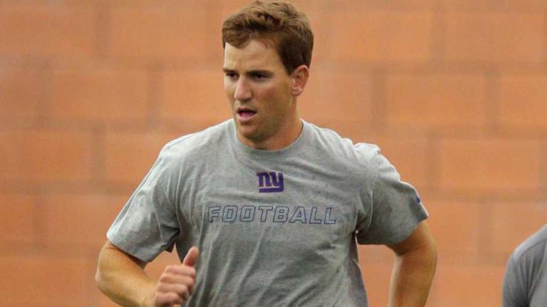 New York Giants quarterback Eli Manning runs during team conditioning drills at the Quest Diagnostics Training Center in East Rutherford, N.J., on Thursday, July 30, 2015.