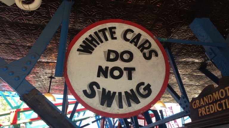 A sign notifies passengers that white cars don't swing on May 25, 2015.