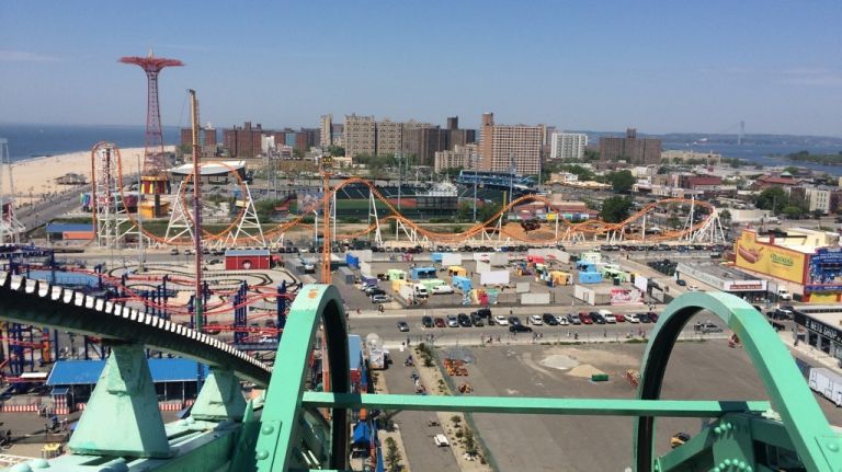 Cresting the Wonder Wheel, the defunct landmark Parachute Jump ride and other classic Coney Island rides come into view on May 25, 2015. 