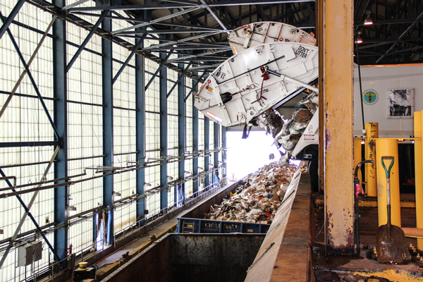 A garbage truck adding a final load of recyclable paper to an open hopper barge, which had already been filled over the past days with about 400 tons of paper. The facility sends five barges per week to Staten Island.   PhotoS by Tequila Minsky