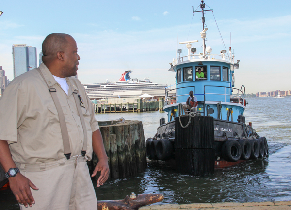 Ernest Mack, who runs the pier, shouts to the tugboat, which will transport the barge to Staten Island where the paper will be made into pizza boxes, among other things.