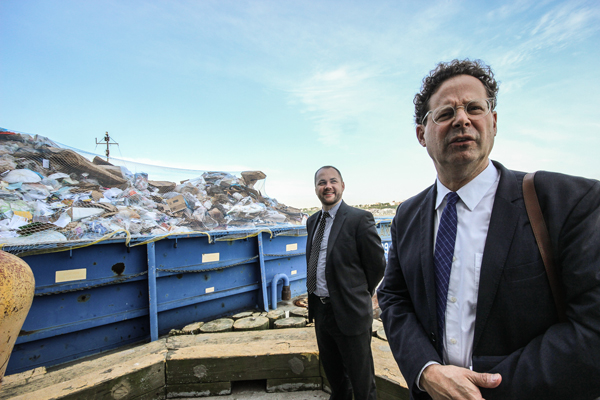 Corey Johnson, left, and Adam Weinberg at the end of the W. 59th St. pier as a paper-laden barge is floated out into the river.   Photo by Tequila Minsky