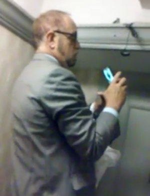Arthur Schwartz disconnecting the surveillance cameras on June 11. The blue object is his cell phone.   Photo by Jessica Berk