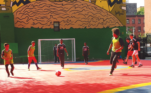 Budding soccer stars enjoyed breaking in the new mini-pitch next to East Side Community High School on June 10.   Photos by Kristin Rubisch/University Settlement