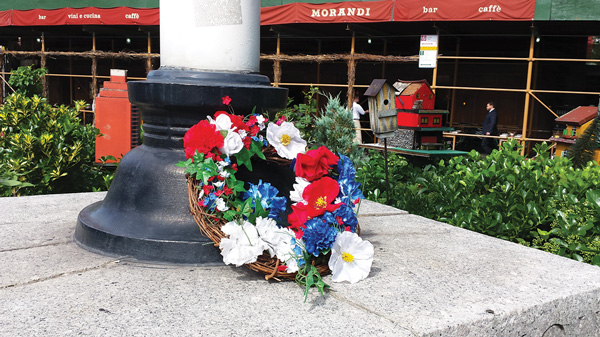 On Sat., July 4, at McCarthy Square, a wreath had been laid on a monument to those who served in the armed forces during World War II. Past the birdhouses, in the background is Morandi restaurant, which is separated from the small triangle park by a short stretch of Waverly Place, which D.O.T. is proposing to close to traffic.  Photo by Lincoln Anderson