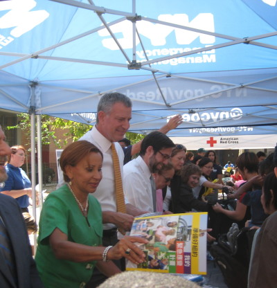 Mayor de Blasio, flanked by U.S. Rep. Nydia Velazquez, and State Sen. Daniel Squadron, handing out "Go Bags" Thursday, the same day he announced $100 million of storm protection for Lower Manhattan. Downtown Express photo by Dusica Sue Malesevic.