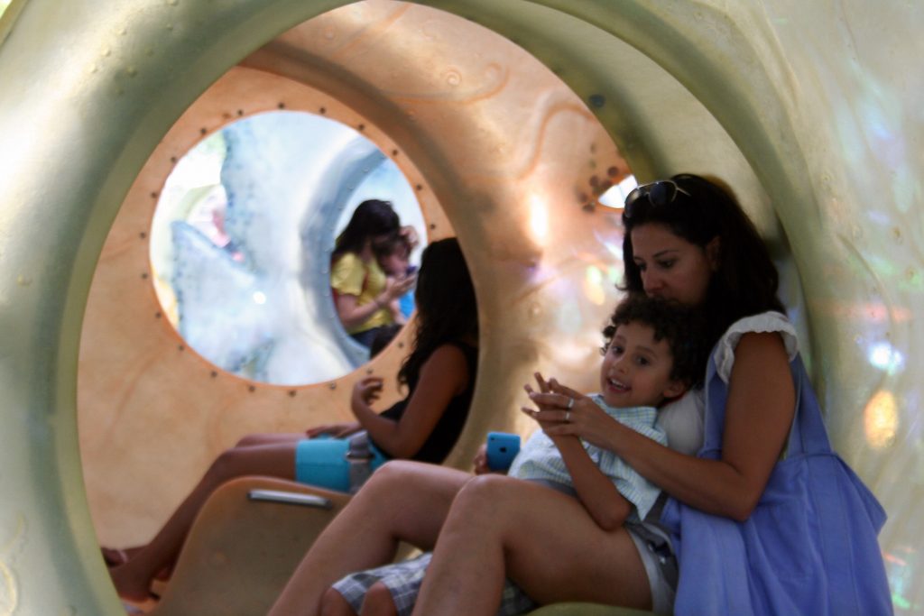 The Battery's SeaGlass carousel wows tourists & residents opening day 11 Sharon Arang with her four-year-old son, Ari, inside the carousel.