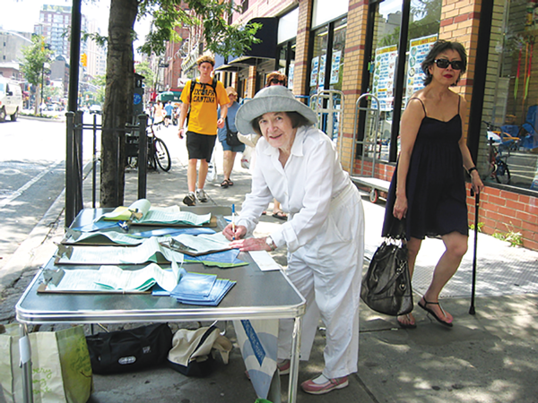 Doris Corrigan manning a petitioning table for getting local candidates on the 2010 ballot.   Photo by Donathan Salkaln