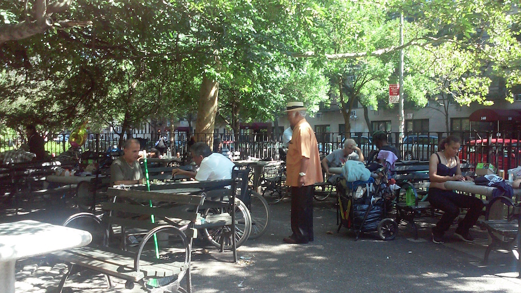 Another man sleeping on a bench in Tompkins Square Park.