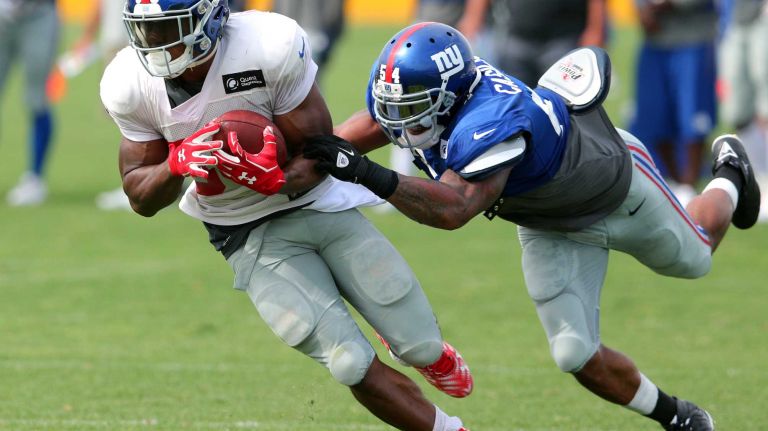 New York Giants tight end Jerome Cunningham makes a catch in front of linebacker Jonathan Casillas during training camp at the Quest Diagnostics Training Center in East Rutherford, N.J., on Saturday, Aug. 8, 2015.