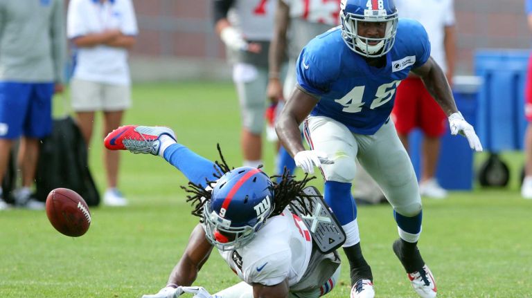 New York GIants wide receiver Geremy Davis misses a pass while defended by cornerback Chandler Fenner during training camp at the Quest Diagnostics Training Center in East Rutherford, N.J., on Saturday, Aug. 8, 2015.