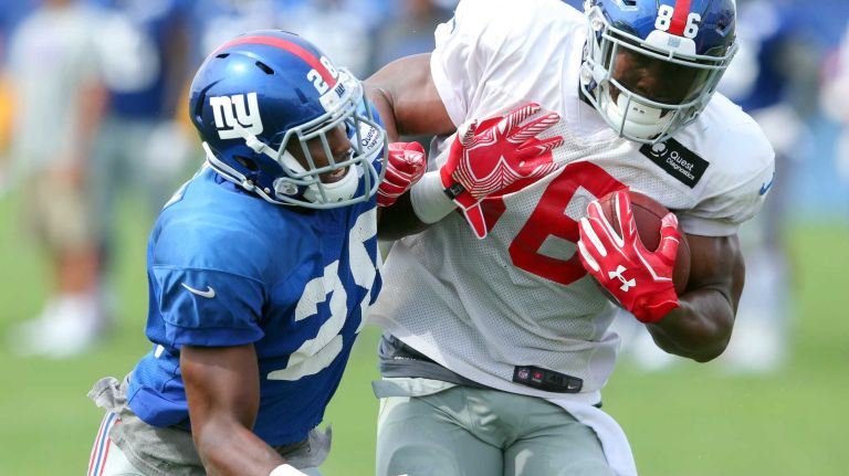 New York Giants tight end Jerome Cunningham runs the ball against cornerback Jayron Hosley during training camp at the Quest Diagnostics Training Center in East Rutherford, N.J., on Saturday, Aug. 8, 2015.