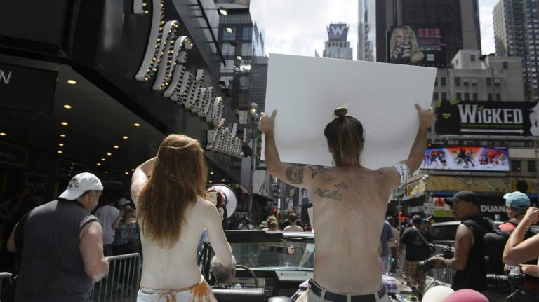 Participants, some topless, march in midtown Manhattan during an event marking International Go Topless Day on Sunday, August 23, 2015. The event was independent of, but coincide with, the apparent proliferation topless tip seeking women in Times Square.