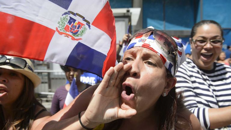 A spectator at the 34rd annual Dominican Day Parade boos New York City Mayor de Blasio as he marches past her on Sunday, August 09, 2015. The Dominican Day Parade promotes the richness of the culture, folklore and popular traditions of the Dominican Republic.