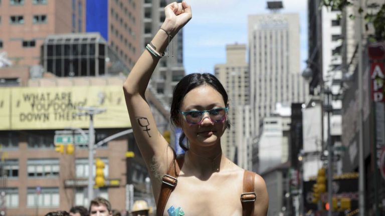 Participants, some topless, march in midtown Manhattan during an event marking International Go Topless Day on Sunday, August 23, 2015. The event was independent of, but coincide with, the apparent proliferation topless tip seeking women in Times Square.
