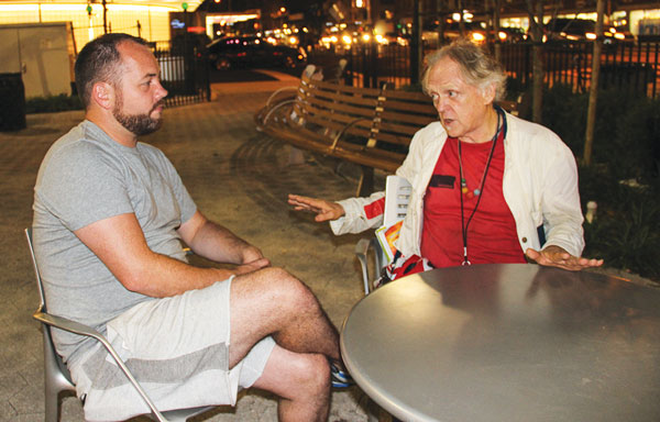 Hospital triangle goes ‘back to the land’ as new park opens; AIDS memorial is coming next 5 Councilmember Corey Johnson, left, and activist Jim Fouratt had a discussion in the park later that evening.