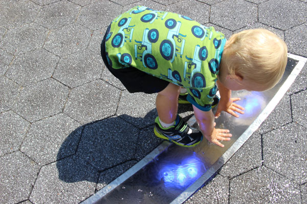 Hospital triangle goes ‘back to the land’ as new park opens; AIDS memorial is coming next 2 A little boy in the new park investigates a fountain that has lights beneath it. Photos by Tequila Minsky