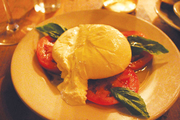 Gotta try the Burrata — a perfect lump of gooey, salty mozzarella on deliciously ripe local tomatoes.  Photo by James William Hudson
