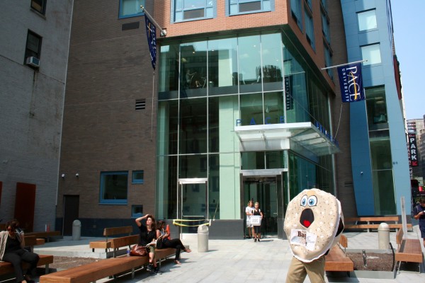 Pace students and "Chris the Dancing Bagel" were outside the university's new Beekman St. dorm Thursday. Downtown Express photo by Yannic Rack. 
