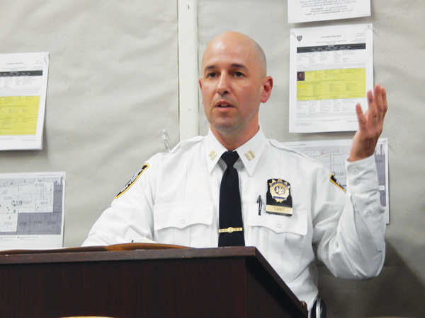 Captain Paul Lanot, the commanding officer of the 10th precinct, behind the podium at his first Community Council meeting. Photo by Sean Egan.