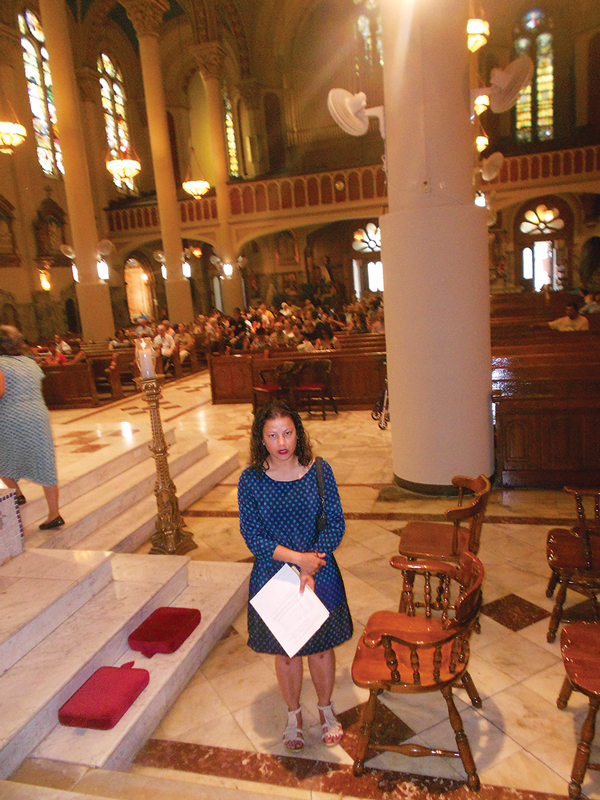 Cristina Tejada, a former Nativity parishioner, at Most Holy Redeemer before the start of a Mass.  Photo by Mary Reinholz