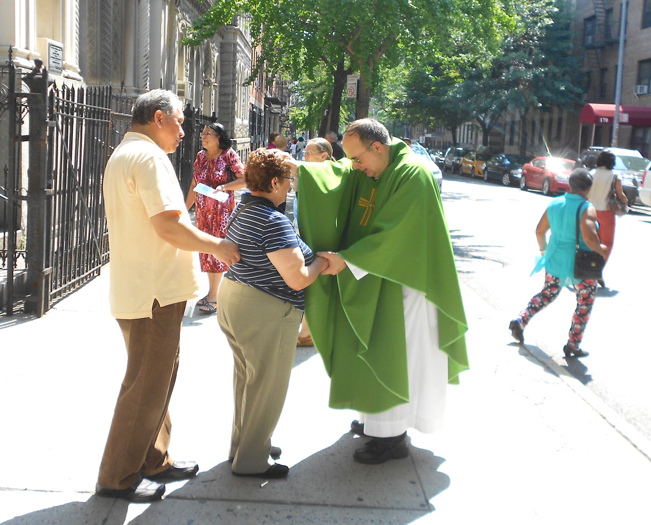 Reverend James Cascione and congregants outside Most Holy Redeemer after a recent Sunday Spanish-language Mass.  Photo by Mary Reinholz