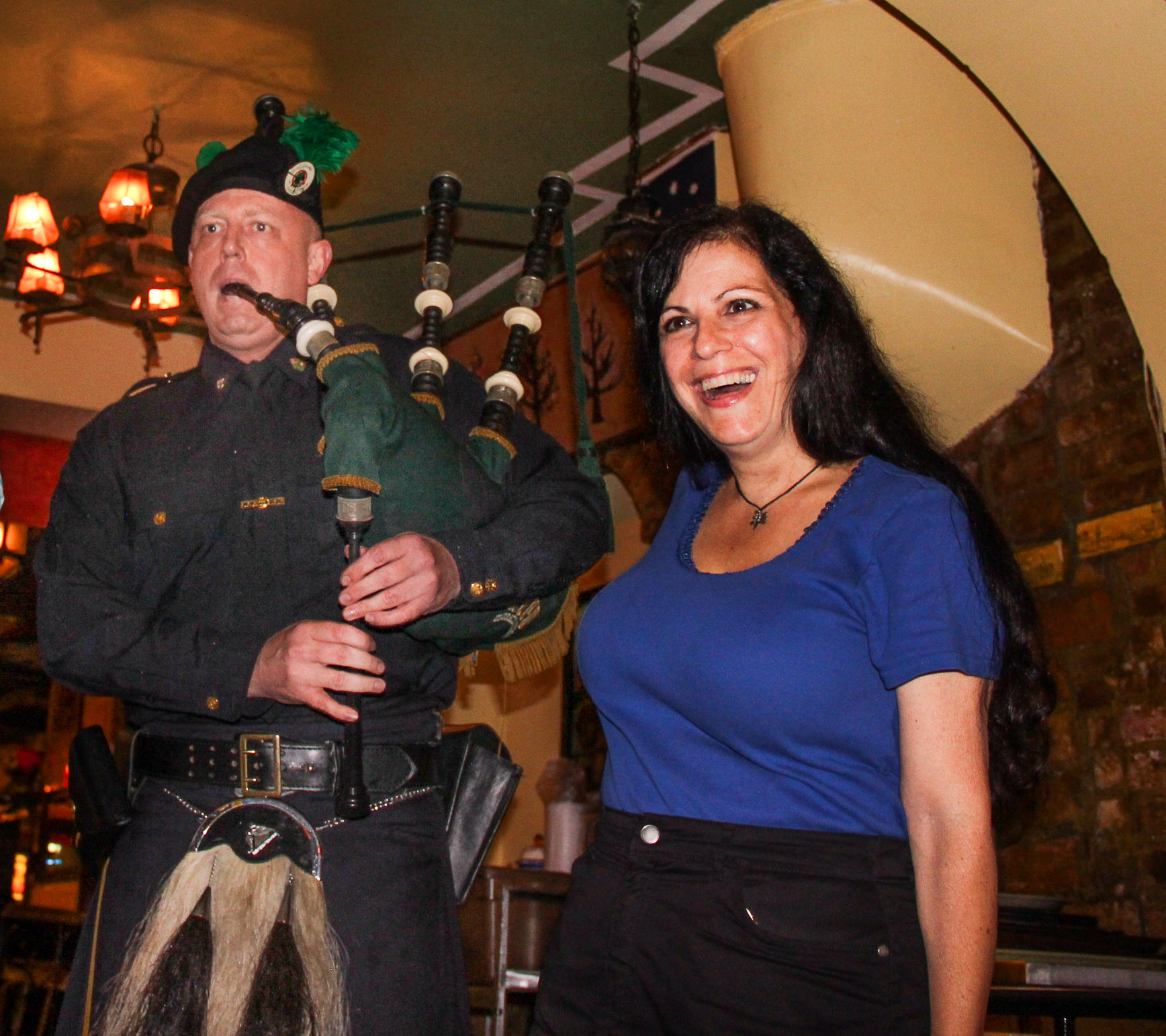 Bagpiper Robert Gault, brother of Dennis Gault, celebrated with Terri Cude last Thursday. Downtown Express photo by Tequila Minsky.  